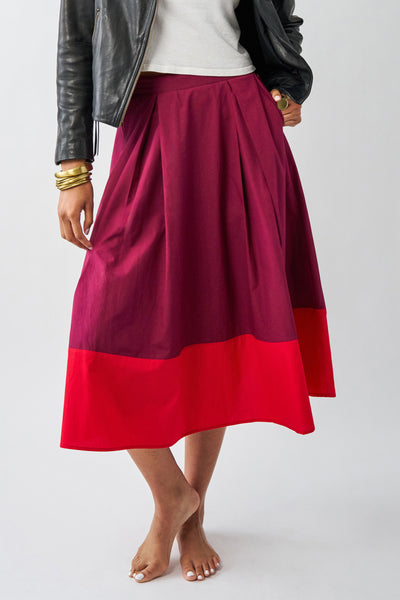 a-line midi skirt with a color blocked design in poppy red and burgundy