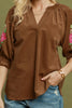 camel brown corduroy top with colorful embroidered floral details on sleeves.
