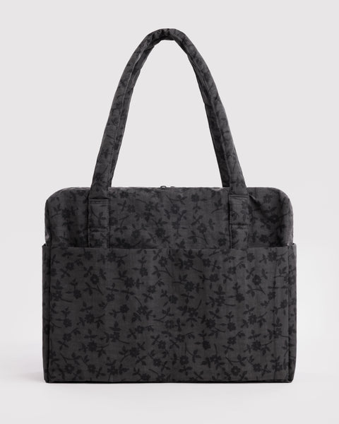 carry-on bag in a charcoal ditsy floral pattern