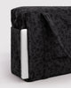 carry-on bag in a charcoal ditsy floral pattern