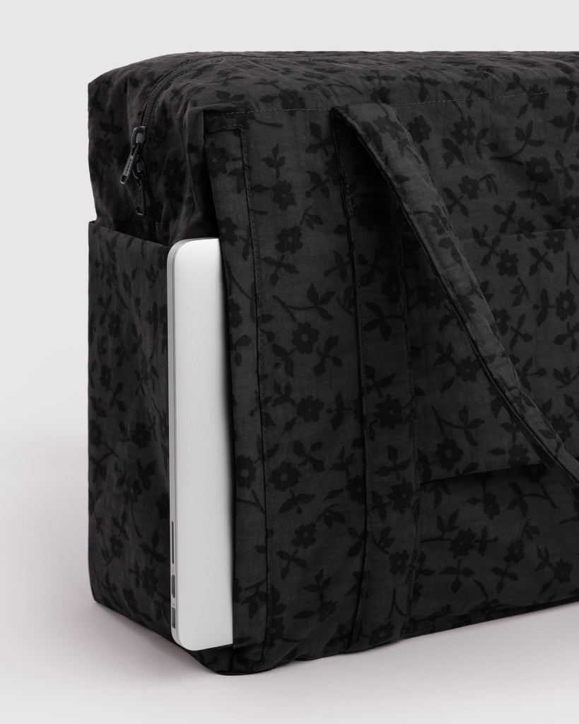 carry-on bag in a charcoal ditsy floral pattern