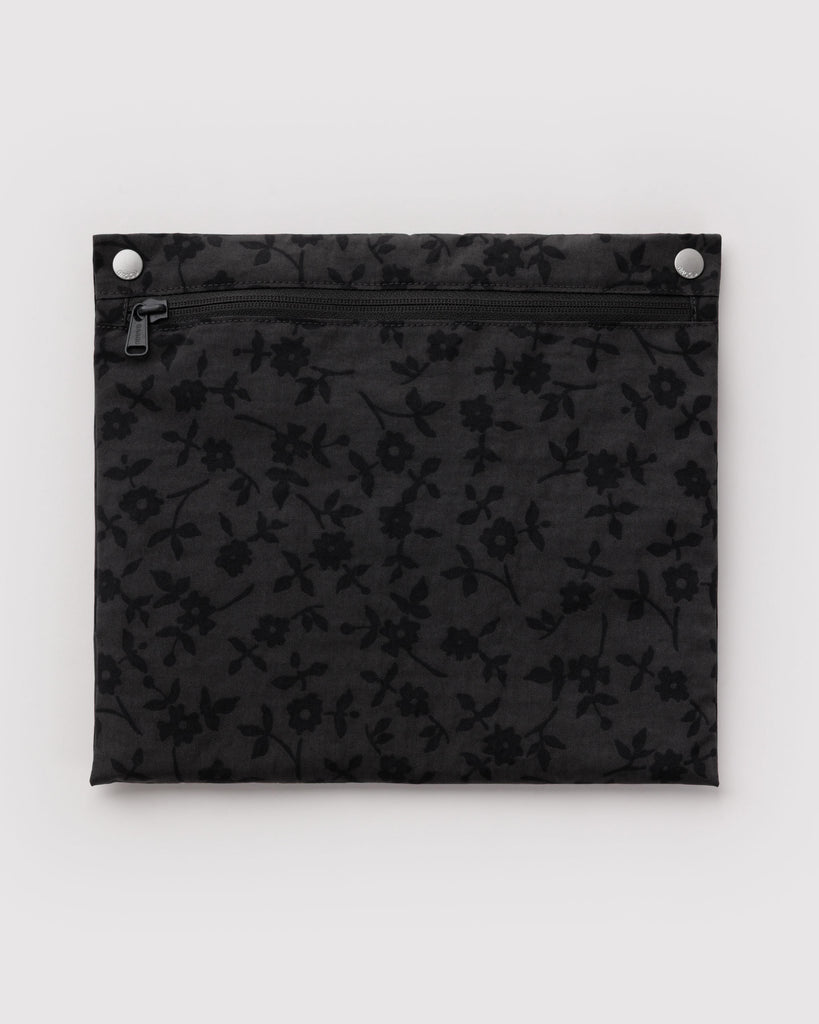 carry-on bag in a charcoal ditsy floral pattern