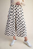 white wide leg pants with trendy black polka dots throughout