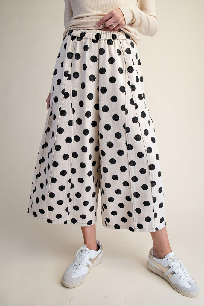 white wide leg pants with trendy black polka dots throughout