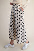 white wide leg pants with trendy black polka dots throughout