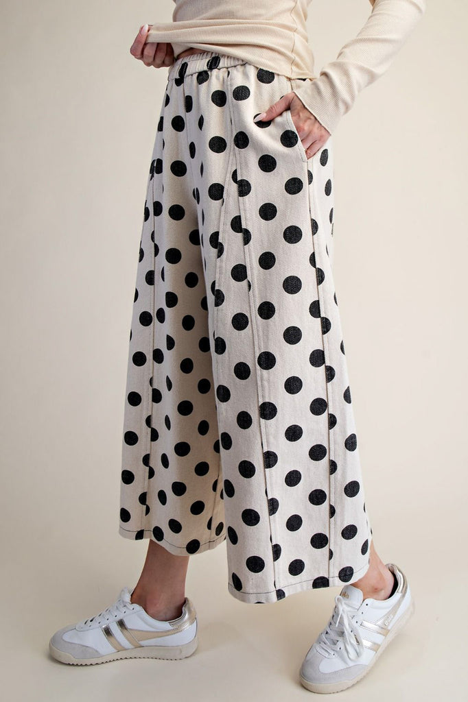 white wide leg pants with trendy black polka dots throughout