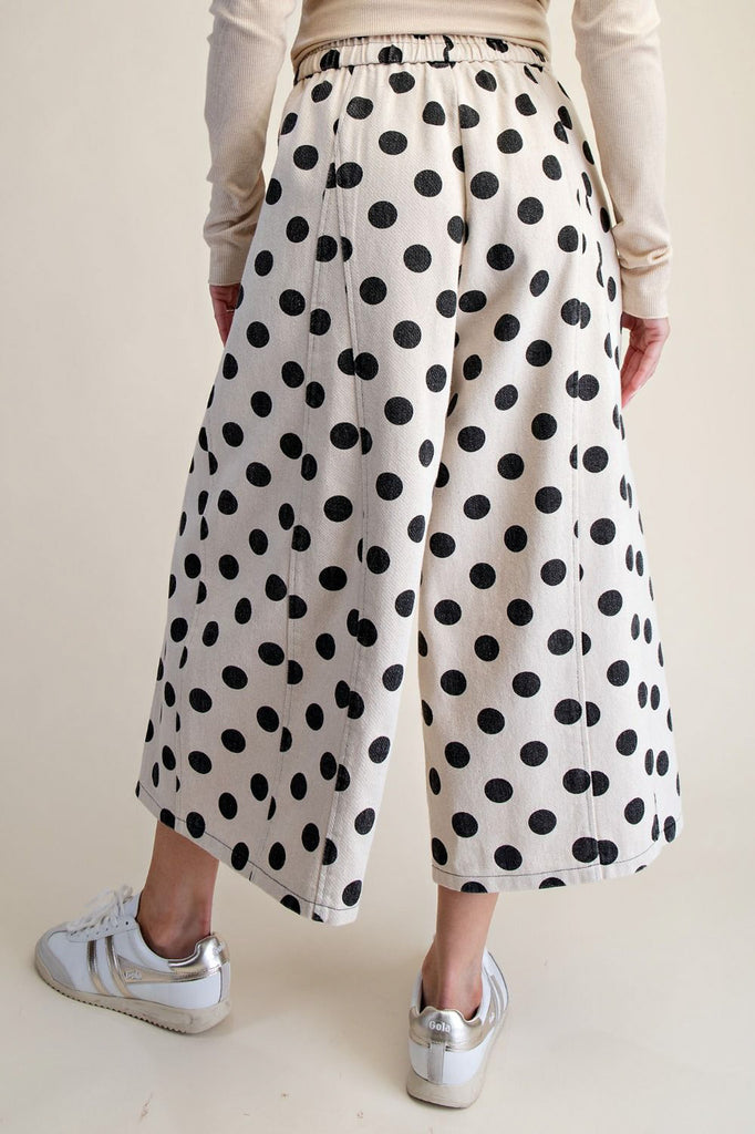white wide leg pants with trendy black polka dots throughout