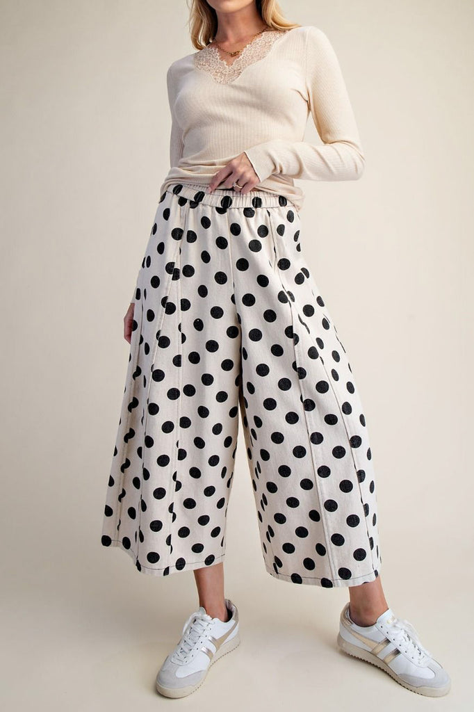 white wide leg pants with trendy black polka dots throughout