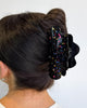 large black hair claw with colorful rainbow confetti glitter