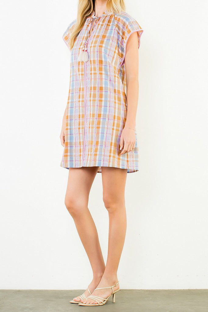 shift dress in a summery plaid pattern with ruffled neckline and tie detail