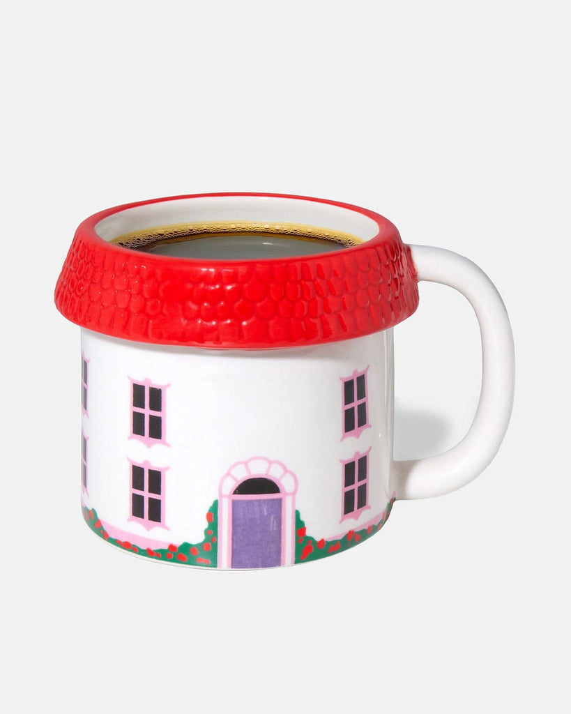 oversized three dimensional mug in the shape of a cozy cottage