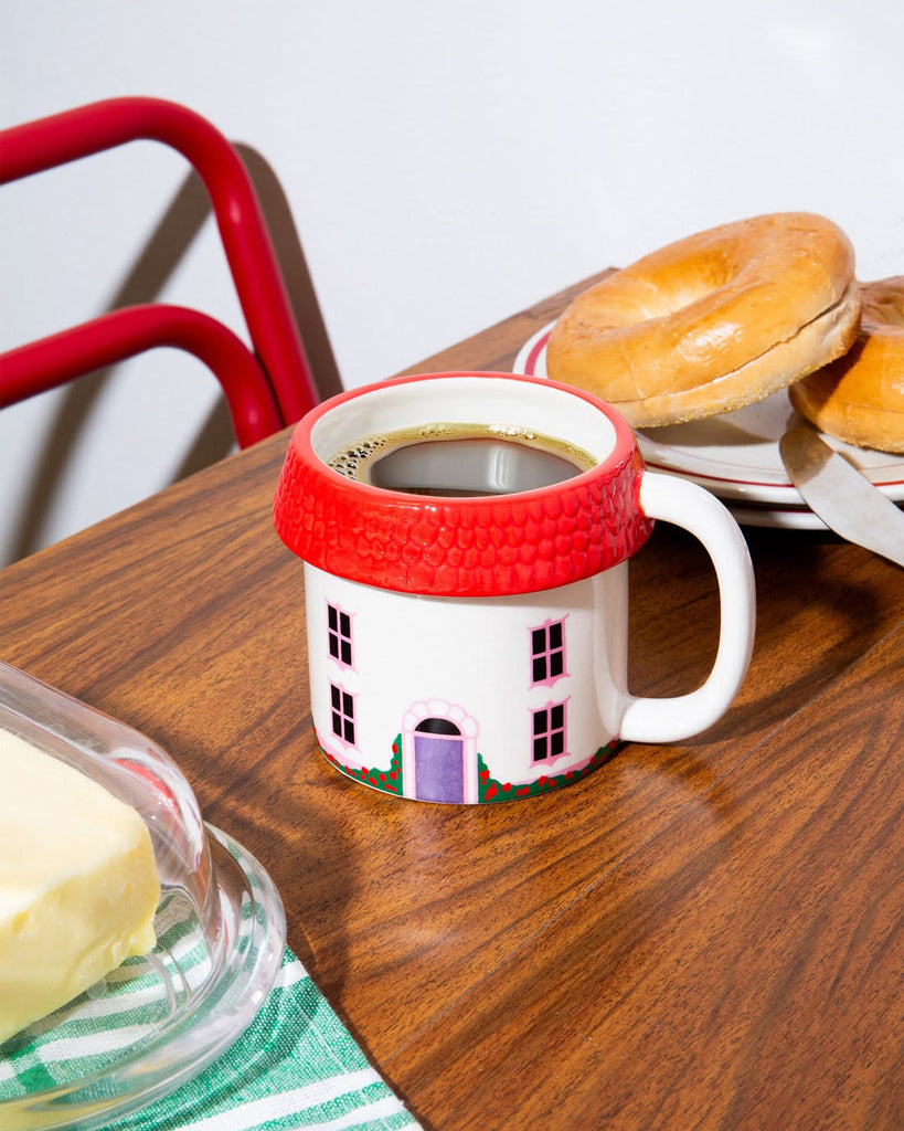 oversized three dimensional mug in the shape of a cozy cottage