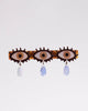 alligator clip featuring three eyes with teardrop details 