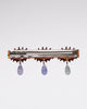 alligator clip featuring three eyes with teardrop details 