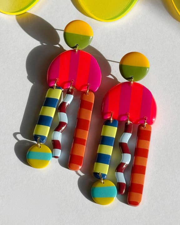 Colorful earrings with striped design on a white background