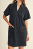 washed black denim mini dress with a collared v neckline and front patch pockets 