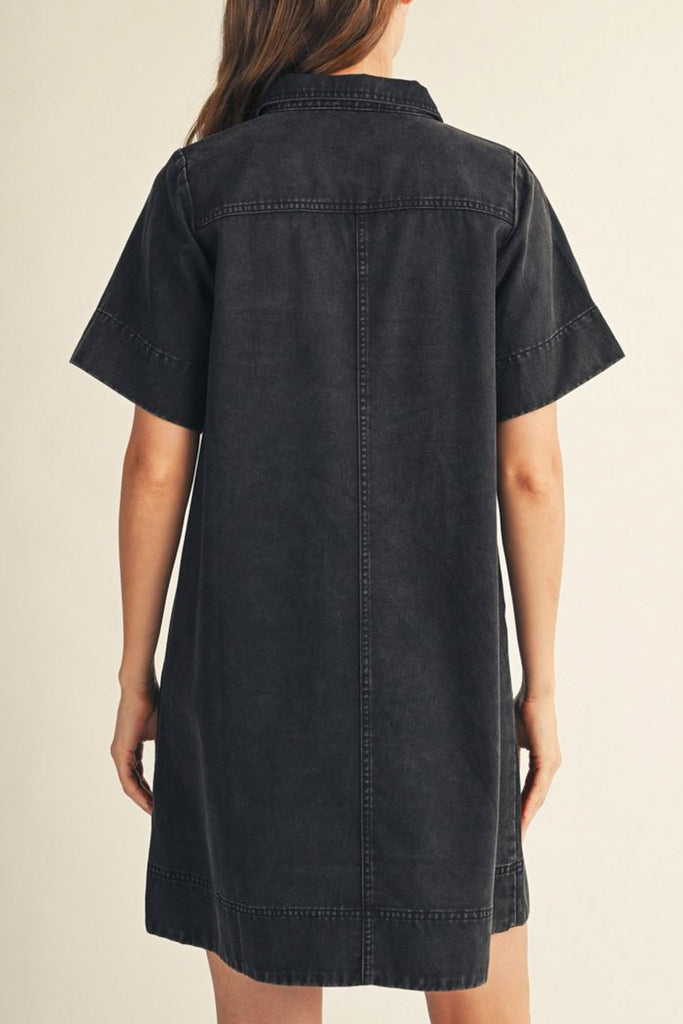 washed black denim mini dress with a collared v neckline and front patch pockets 
