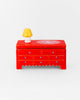 ceramic trinket box in the shape of a red dresser
