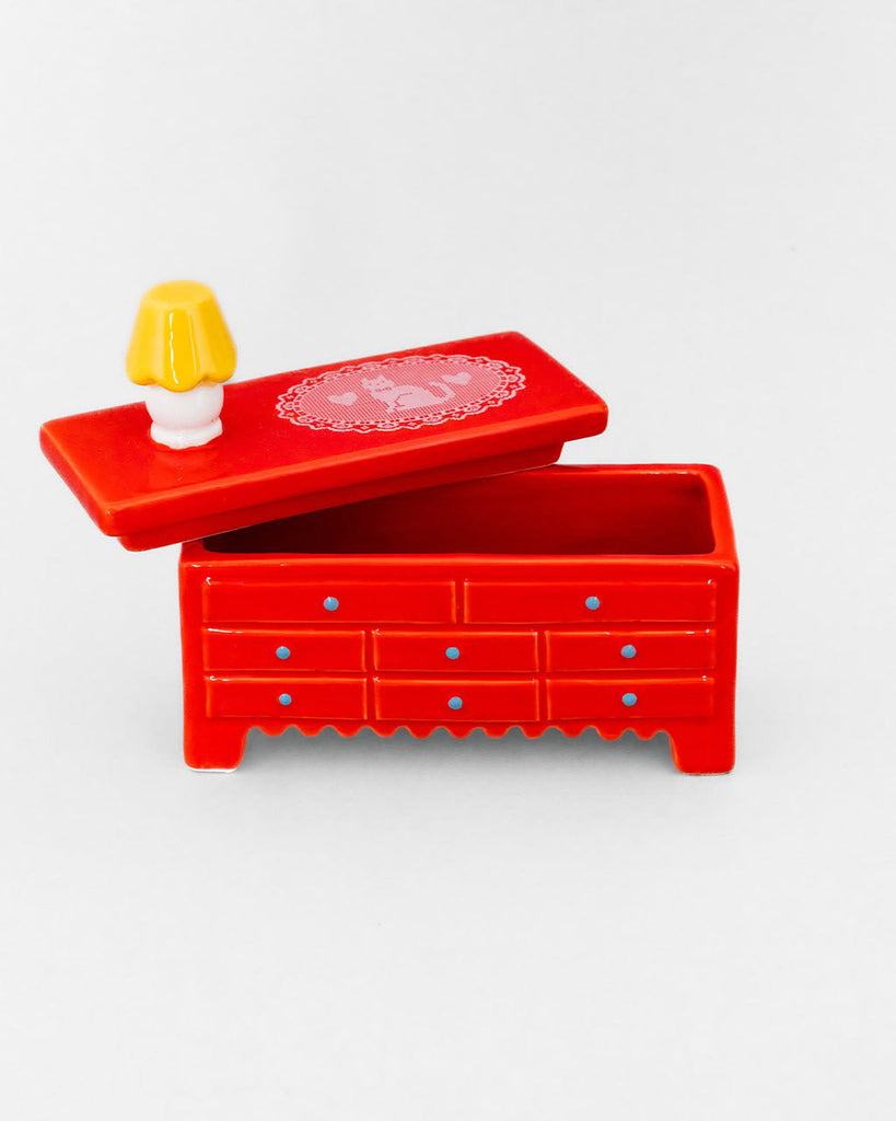 ceramic trinket box in the shape of a red dresser