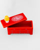 ceramic trinket box in the shape of a red dresser