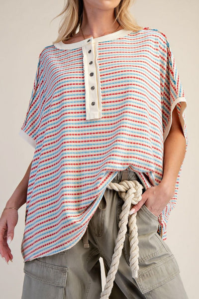 oversized cream colored top in turquoise and red stripes