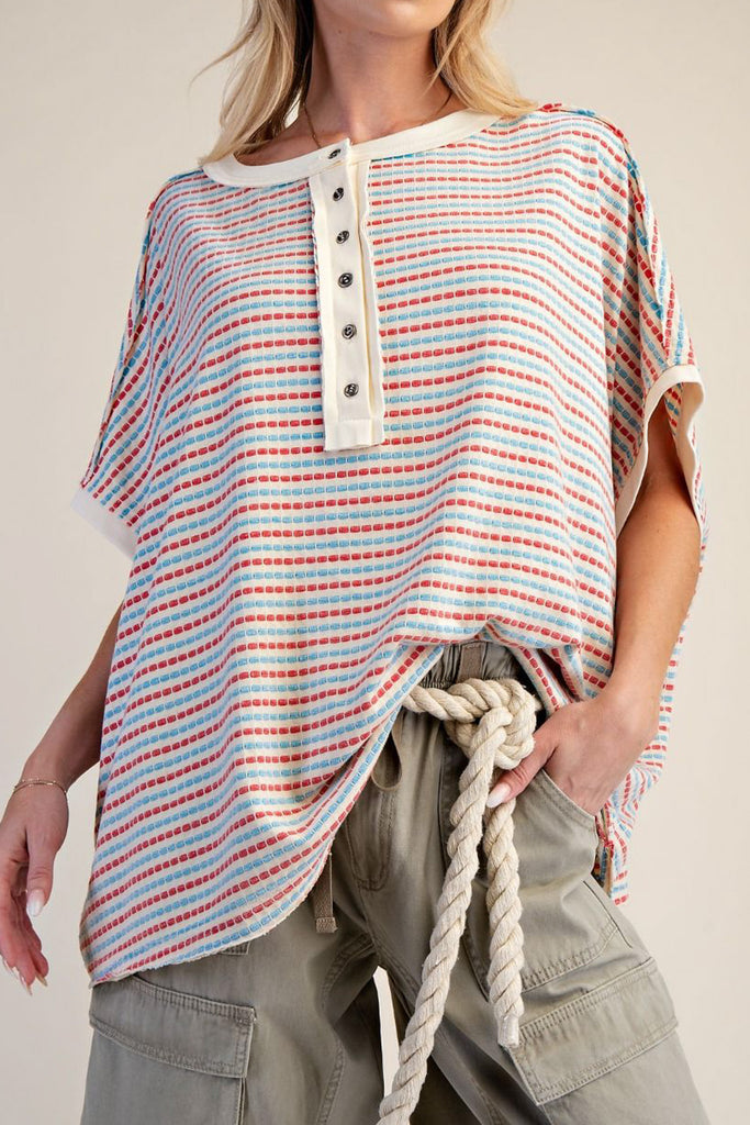 oversized cream colored top in turquoise and red stripes