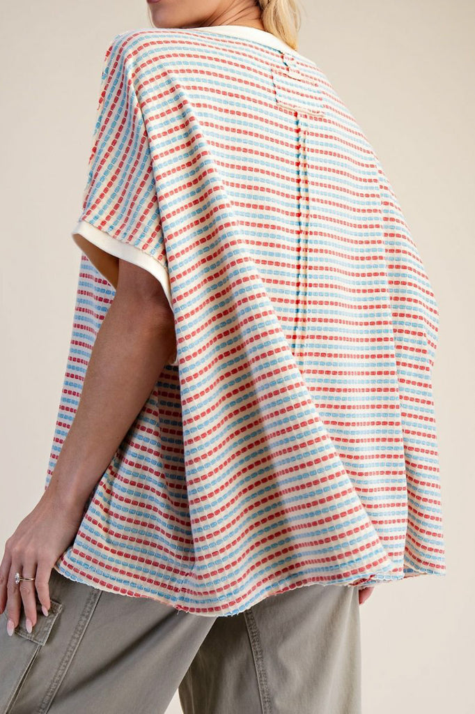 oversized cream colored top in turquoise and red stripes