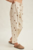 off white trousers with cute polka dots in deep ochre