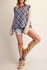 oversized knit sweater vest in chocolate brown with a sky blue argyle-inspired floral pattern 