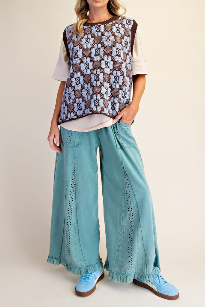 oversized knit sweater vest in chocolate brown with a sky blue argyle-inspired floral pattern 
