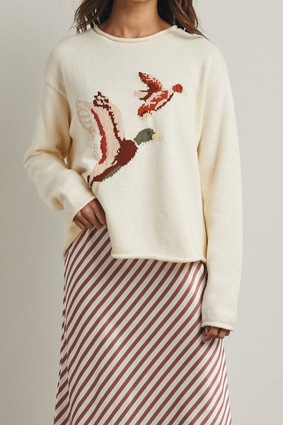 cream colored sweater with a cute knit flying duck knit graphic