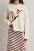 cream colored sweater with a cute knit flying duck knit graphic