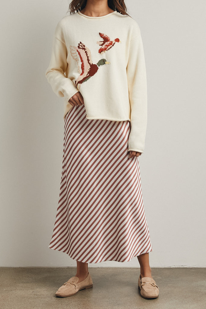 cream colored sweater with a cute knit flying duck knit graphic