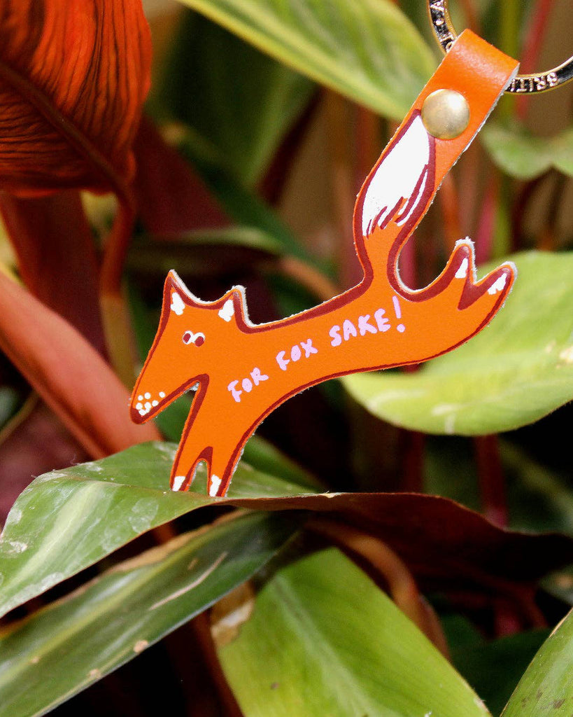 genuine leather key fob in the shape of a fox with the message "for fox sake!"