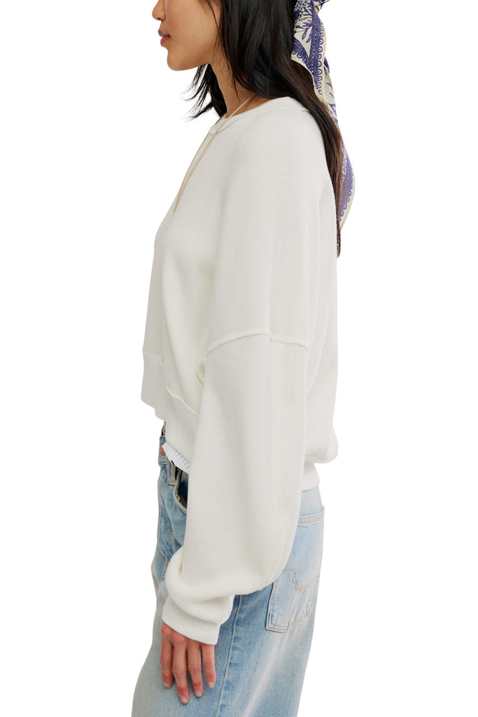 white long sleeve tee with dropped shoulders and a cropped length