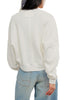 white long sleeve tee with dropped shoulders and a cropped length