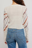 free people fitted white cardigan with a muted plaid design.
