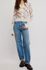free people fitted white cardigan with a muted plaid design.