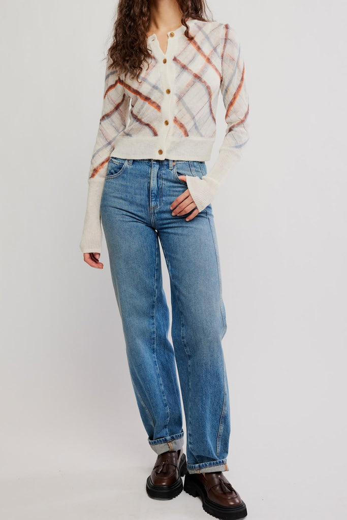 free people fitted white cardigan with a muted plaid design.