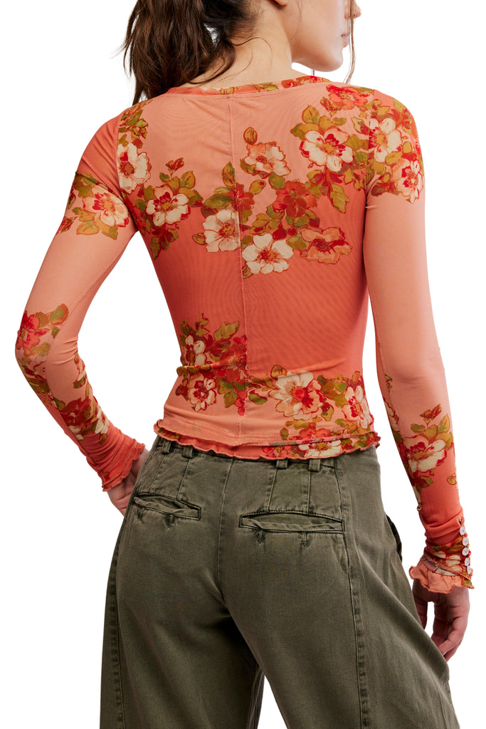 free people mesh long sleeve top in a peachy apricot color with a lovely floral design.