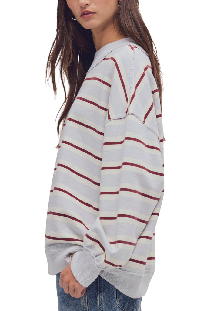 free people oversized pullover in washed sky blue, white, and burgundy stripes.