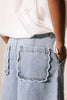 scalloped trim on back pockets and frnch logo embroidery