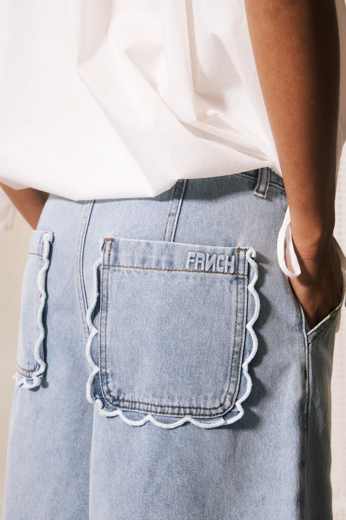 scalloped trim on back pockets and frnch logo embroidery
