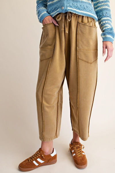 washed ochre pull on pants with unique pocket detailing and exposed seams throughout