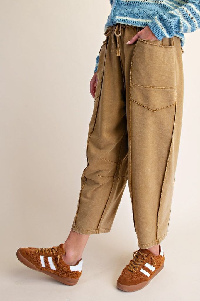 washed ochre pull on pants with unique pocket detailing and exposed seams throughout