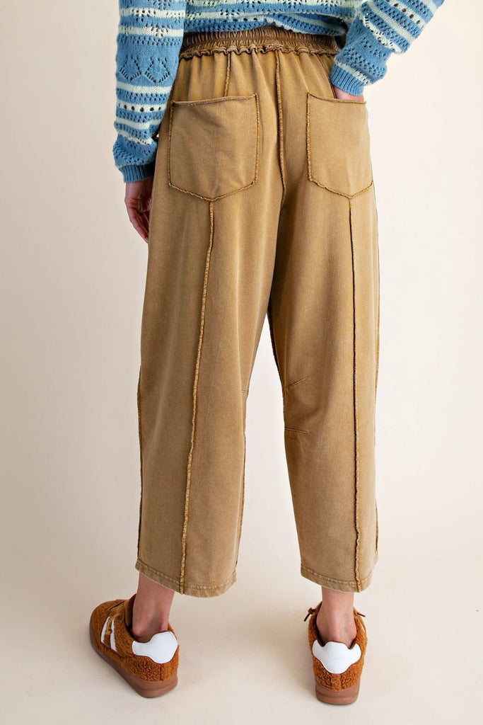 washed ochre pull on pants with unique pocket detailing and exposed seams throughout