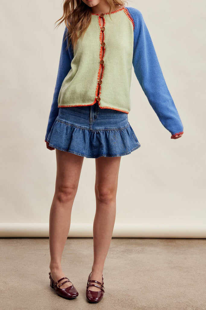 knit raglan-style cardigan with a color blocked design and special blanket stitched details