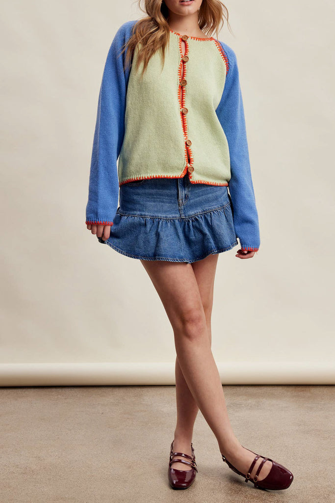 knit raglan-style cardigan with a color blocked design and special blanket stitched details