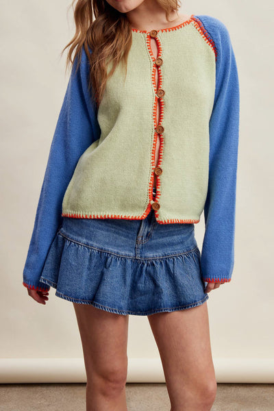 knit raglan-style cardigan with a color blocked design and special blanket stitched details