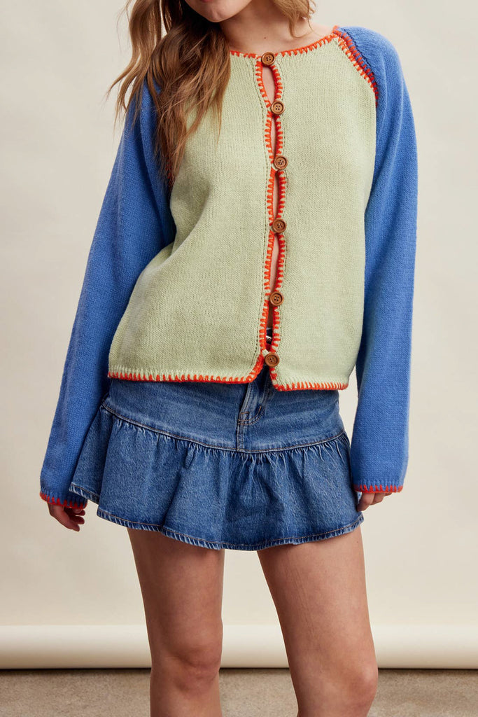 knit raglan-style cardigan with a color blocked design and special blanket stitched details